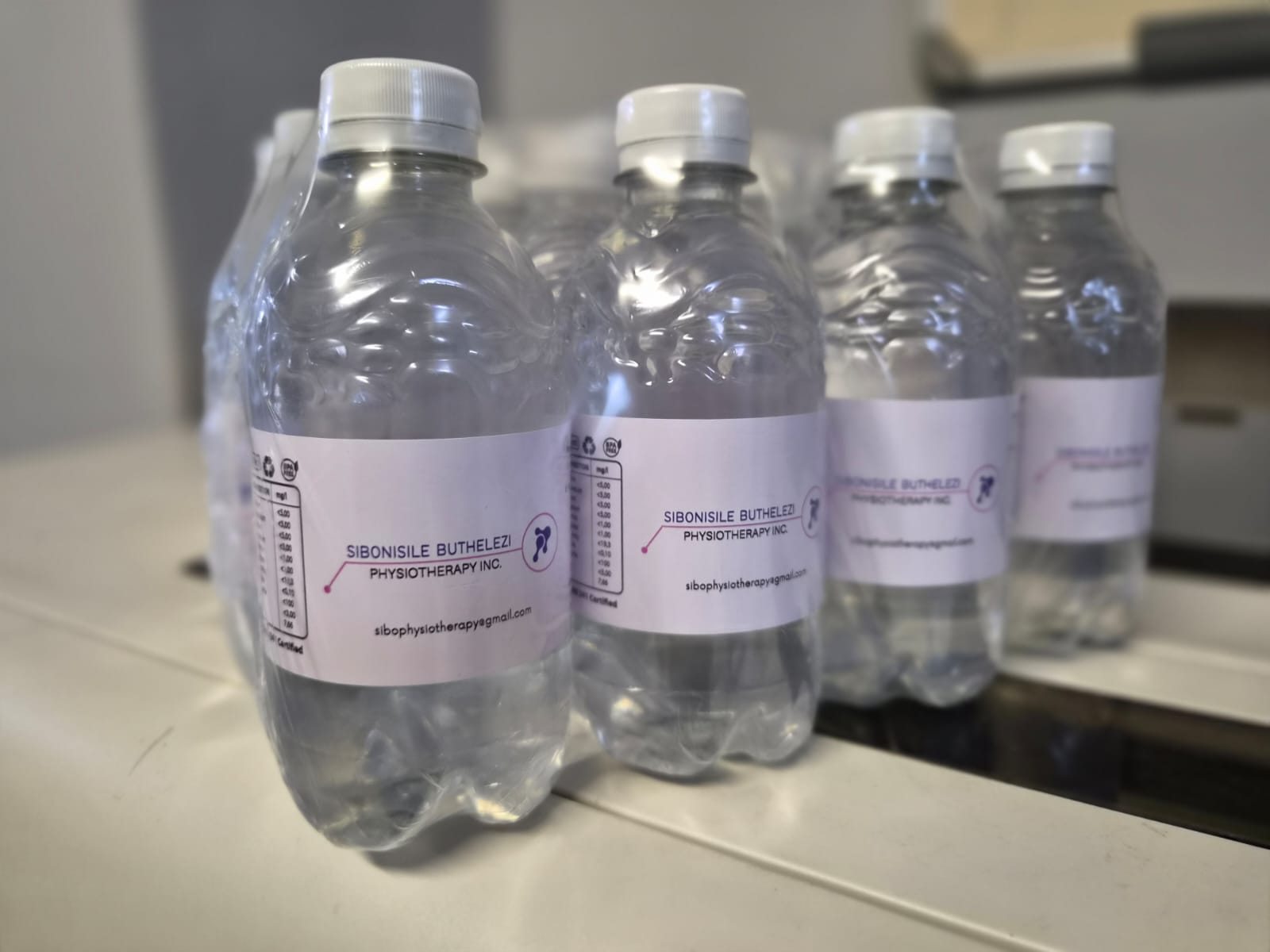 Water bottles with custom printed labels by Indota Prints
