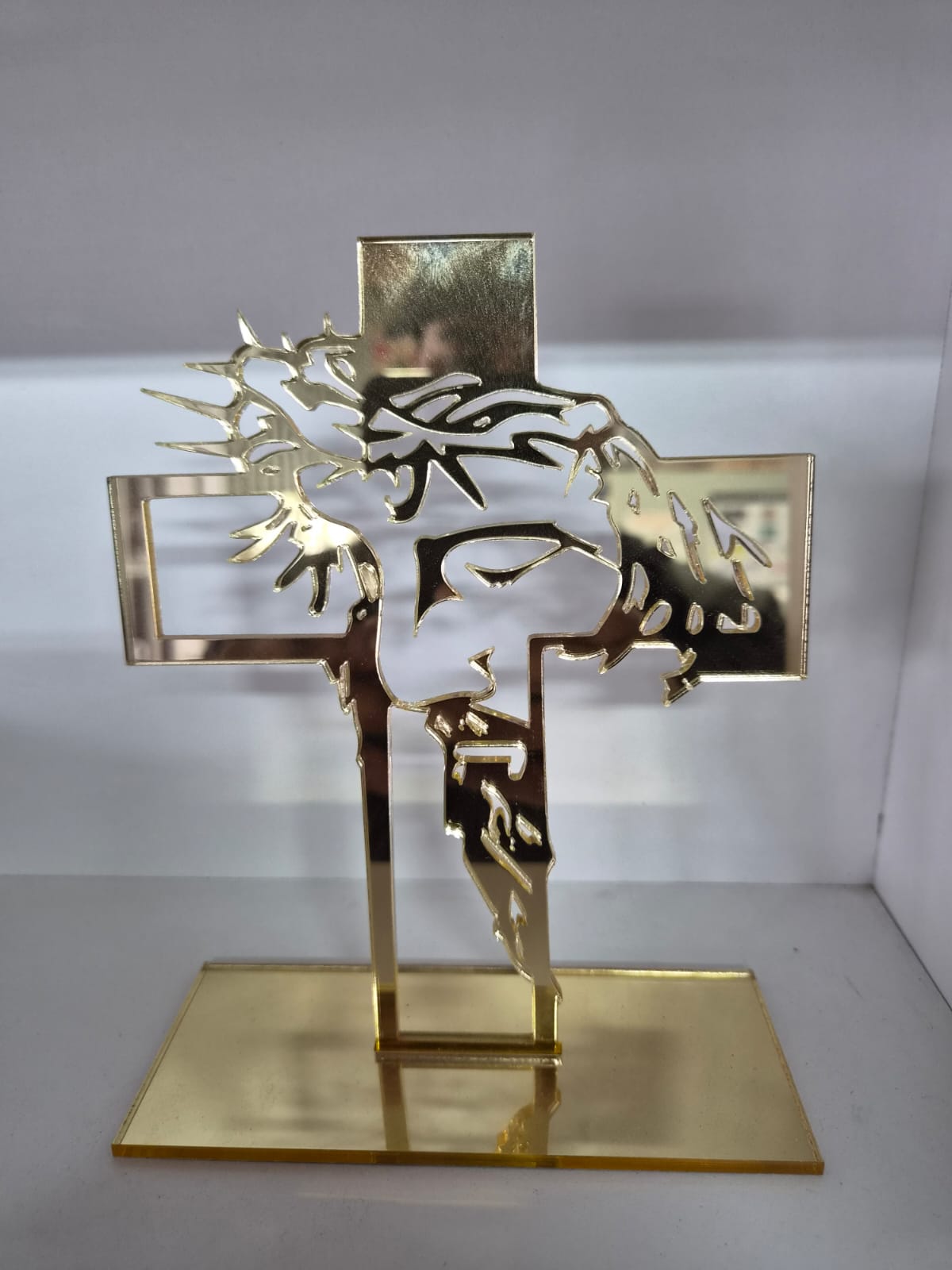 Laser-cut gold mirror cross on a stand, made by Indota Prints